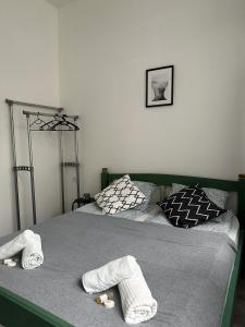 a bedroom with two beds with towels on them at Dolce Vita Budapest in Budapest