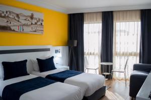 Voodi või voodid majutusasutuse Hotel Le Musée toas