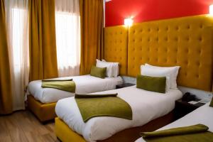 Voodi või voodid majutusasutuse Hotel Le Musée toas