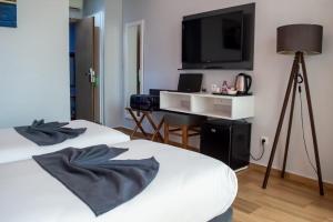 Voodi või voodid majutusasutuse Hotel Le Musée toas