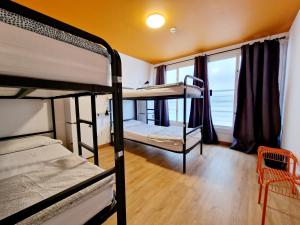 a room with three bunk beds and a window at Arc House Barcelona in Barcelona