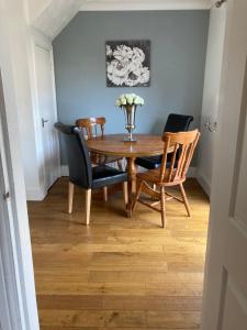 a dining room with a wooden table and chairs at Tempest House 3 bedroom in Hartlepool