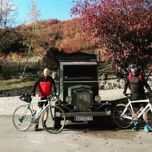 two men standing in front of a car with their bikes at Apartman Andrić in Višegrad +7 photos