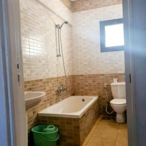 a bathroom with a tub and a toilet and a sink at Chalet 3 bedrooms 2 toilets lotus north cost stand alone 3 air conditioner families are preferred available all year days & 3 blankets available in El Alamein