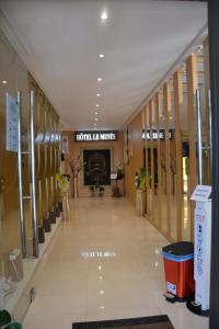 a lobby of a building with a hotel music sign at Hotel Le Musée in Rabat