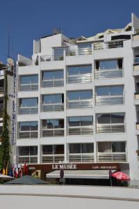 a white building with an ice music sign on it at Hotel Le Musée in Rabat