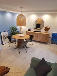a living room with a table and a mirror at EvaMaria apartments in Poreč