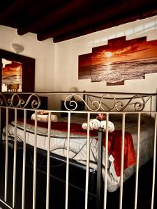 a bed in a bedroom with a metal railing at La Trinacria in Agrigento