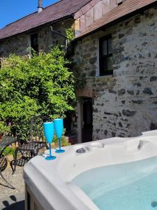 two blue glasses sitting on top of a bath tub at Snuggle hot tub Dolgoy in Llwyn-Dafydd