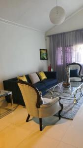 a living room with a couch and a glass table at Caribbean Estates, 10 mins from the Beach, Beautiful Gated Community in Portmore