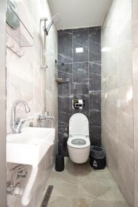 a bathroom with a white toilet and a sink at Beyoğlu Huzur Apart in Istanbul