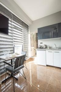 a kitchen with a table and a dining room at Beyoğlu Huzur Apart in Istanbul