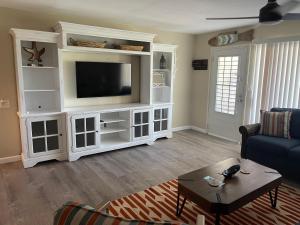 a living room with a large white entertainment center at Sun-Days at Crystal Cove on Sapphire Beach in East End