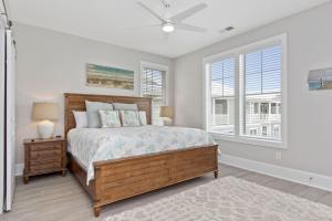 a bedroom with a bed and two windows at Isle of Dreams in Emerald Isle