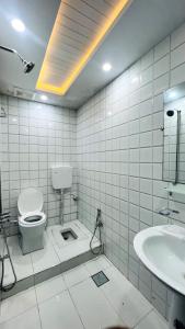 a bathroom with a toilet and a sink at HOTEL 11 SWEET ROOMS in Islamabad