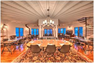 a large room with a large table and chairs at Villa Santorini in Gary