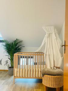 a crib in a room with a plant at (PLANT ROOM 5) Mit Familie oder auch mit Freunde in Halle an der Saale