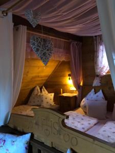 a bedroom with a bed with a wooden ceiling at Ferienhaus Pliescherhof in Turnau