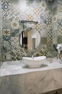 a bathroom with a white sink and a mirror at Hotel Awazul Bacalar in Bacalar +72 photos