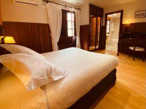 A bed or beds in a room at El Tejo de Comillas