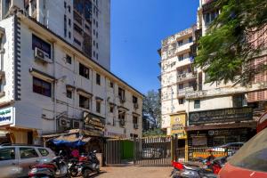 a city street with parked motorcycles and buildings at Hotel Gemini in Mumbai