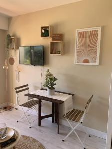 a dining room with a table and chairs and a keyboard at My Little Provence Bormes Les Mimosas in Bormes-les-Mimosas