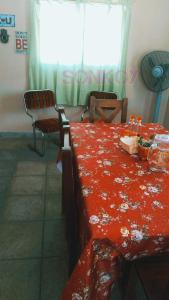 a room with a table with a red blanket on it at SONKOY APART in San Salvador de Jujuy