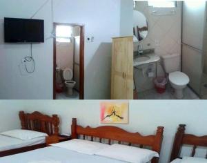 a bathroom with two beds and a sink and a mirror at Engenheiros Hotel - Porto Velho in Porto Velho