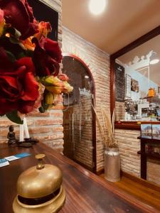 a vase sitting on a table in a room with flowers at El Tejo de Comillas in Comillas