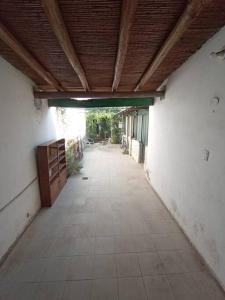 an empty hallway of a building with a wooden ceiling at Monoambiente Full Equipado - La Bussola in Las Heras