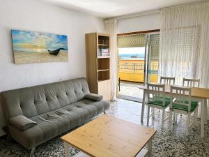 a living room with a couch and a table at Apartamento Careme in Tavernes de Valldigna
