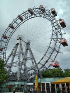 a large ferris wheel in front of a building at CENTER ! 2 stops from the City Center! in Vienna