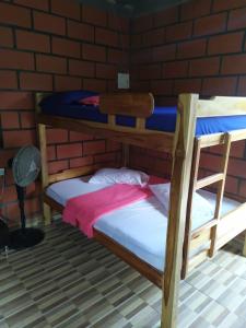 two bunk beds in a room with a brick wall at Cielito Lindo in Necoclí