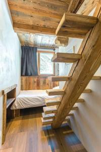 a staircase in a room with a bed and a window at Top floor appartment, ski in ski out, superb view in La Daille