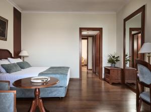 a living room with a bed and a table at Strada Marina Hotel in Zakynthos