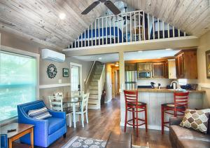 a kitchen and living room with a loft at Treetop River Cabins on the Guadalupe River in Center Point