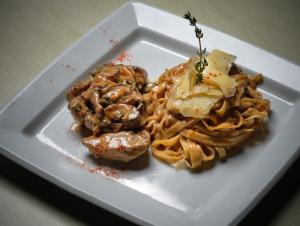 a white plate of food with pasta and sauce at Strada Marina Hotel in Zakynthos