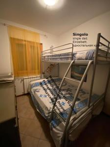 a bedroom with two bunk beds in a room at Confidence house in Gardone Riviera