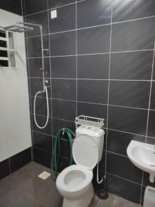 a bathroom with a shower and a toilet and a sink at Homestay Hafiy Manjung Lekir Sitiawan 