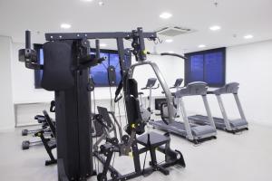 a gym with several tread machines in a room at Intercity Brasilia Led Aguas Claras in Brasília