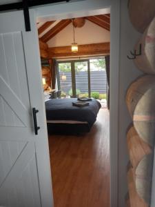 a door leading into a bedroom with a bed at The Cabin in Twizel