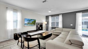 ein Wohnzimmer mit einem Sofa und einem Tisch in der Unterkunft Champions Gate Resort - 9 Bed 5 Baths VILLA in Davenport