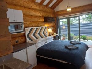 a bedroom with a bed in a log cabin at The Cabin in Twizel