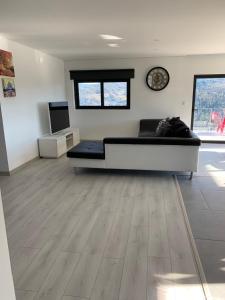 a large living room with a large couch and wooden floors at Casa Bella Vista in Fafe