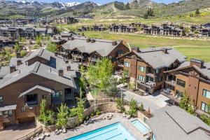 an aerial view of a luxury house with a pool at Walk to Skiing Exceptional 4 Bedroom plus Den Private Hot Tub Golf Course Views Pool in Park City