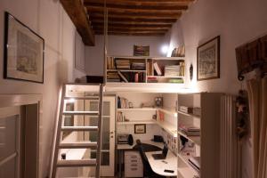 een kamer met een bureau en een boekenplank bij Dimora Coccapani in Pisa