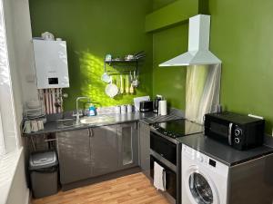 a kitchen with a sink and a washing machine at Windsor stays 1 in Liverpool