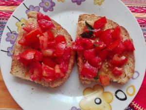 two slices of bread with strawberries on a plate at Simabo's Backpackers' Hostel in Mindelo