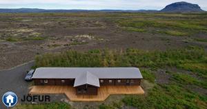 an overhead view of a house in a field at Langahlíð Guesthouse - Privatete Forest - in Hella