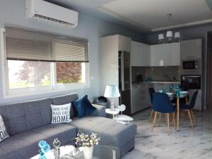 a living room with a couch and a kitchen at Villa Casagrande in Kriopigi +25 photos